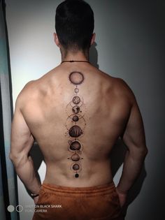 the back of a man's upper body with an image of planets on it