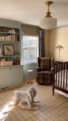 a baby's room with a rocking horse in the middle