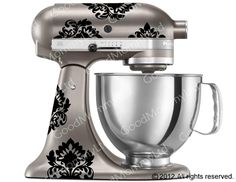 an image of a silver mixer with stickers on it