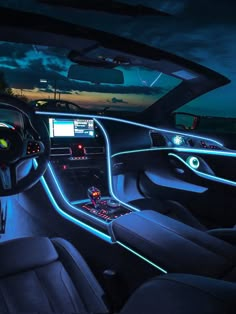 the interior of a car with its lights on and dashboard illuminated by blue leds