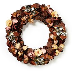 a wreath made out of pine cones and flowers