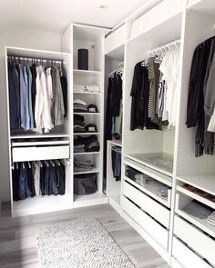 a white closet filled with lots of clothes