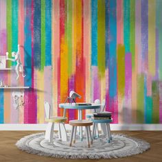 a colorful wallpapered room with two chairs and a table