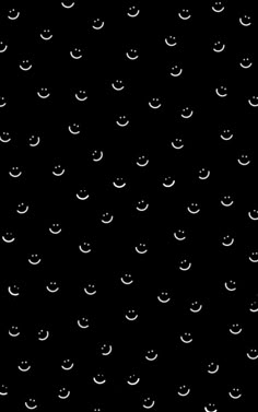 a black background with white smiley faces on it