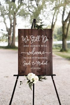 a wooden sign with flowers on it that says we still do and always will welcome guests