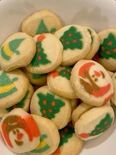 a white bowl filled with christmas cookies on top of a table