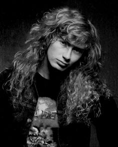 a man with long curly hair wearing a black shirt