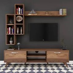 a living room with a large tv on the wall and checkered flooring in front of it