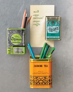 an assortment of teas and pencils in a tin