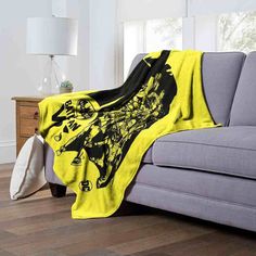 a couch with a yellow and black blanket on it