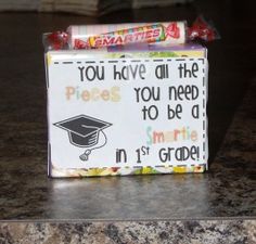 a candy bar wrapper with a graduation cap on it sitting on a granite counter top