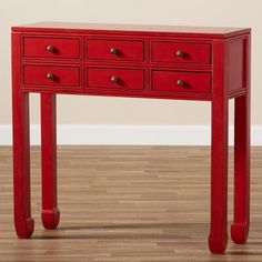 a small red table with drawers on it's sides and one drawer at the top