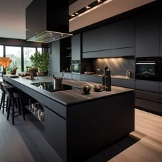 a modern kitchen with black cabinets and an island in the middle is lit by recessed lighting