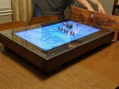 a man standing next to a table with a game on it