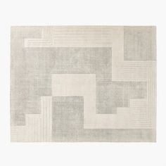 an area rug with squares and rectangles in grey, beige and white colors