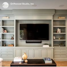 a living room with built in bookshelves and a flat screen tv