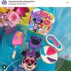 the table is decorated with mickey mouse cookies and other items for sale on instagram