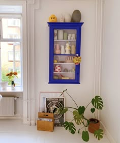 there is a blue shelf on the wall