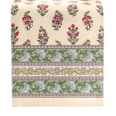 a white and green table runner with red flowers on the border, in front of a white background