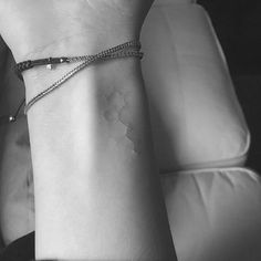 black and white photograph of a woman's wrist with a bracelet on her arm