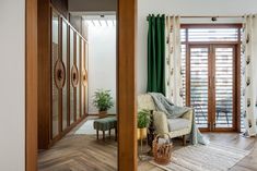 a living room filled with furniture and green curtains