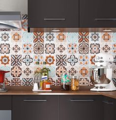 the kitchen counter is covered with colorful tiles