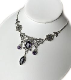 This lovely necklace is made with antiqued silver plated filigrees, adorned with dazzling DEEP VIOLET PURPLE glass rhinestones and jewels. Decorated portion measures 5" wide and 2 1/8" tall in the center. It is adjustable 15" to 18" in length and fastens with a lobster clasp.This is available in a variety of stone colors in our store, along with matching earrings and headpieces. If you don't see something with the stone color you'd like, feel free to send us a message. Victorian Jewelry Necklace, Victorian Necklace, Goth Jewelry, Choker Pendant, Purple Jewelry, Violet Purple, Bridesmaid Wedding, Amethyst Purple, Wedding Jewellery Necklace