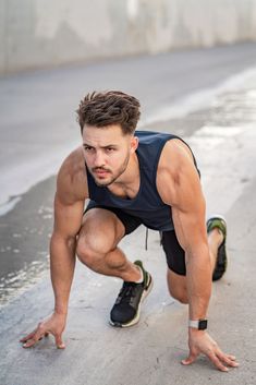 a man is doing push ups on the street