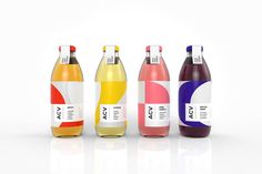 six different types of sodas in bottles on a white surface with reflections from them