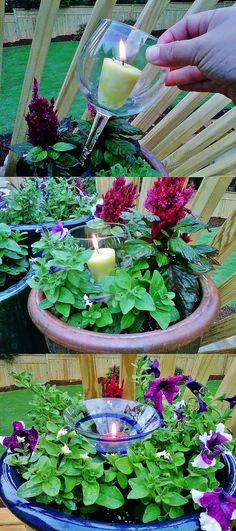 a person is pouring water into a planter with flowers and candles in it on a patio