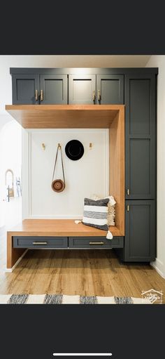 an entryway with built in cabinets and shelves