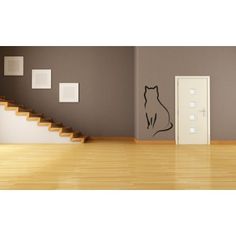 an empty room with stairs and a cat decal on the wall