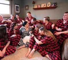 a group of people in red and black flannel pajamas sitting on a couch