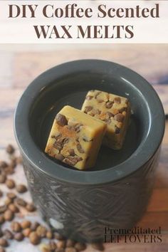 two pieces of coffee scented wax melts in a black bowl on top of some coffee beans