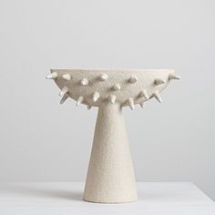 a white sculpture sitting on top of a table