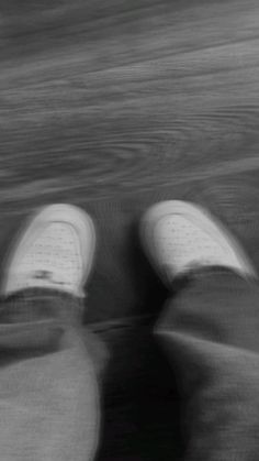 someone is walking on the beach with their shoes