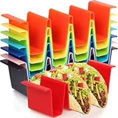 several different colored trays with tacos and mexican food in front of each other