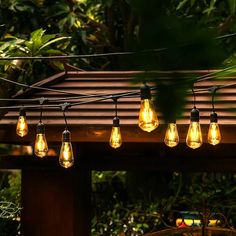 some lights are hanging from a wooden structure