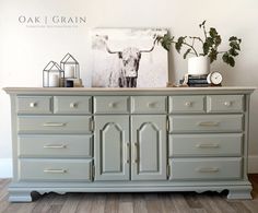 an old dresser has been painted gray with gold handles