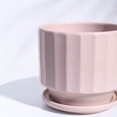 a pink cup sitting on top of a saucer