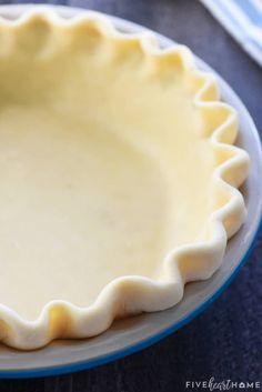 an uncooked pie crust on a blue and white plate