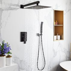 the shower head is mounted on the wall next to the bathtub in the bathroom