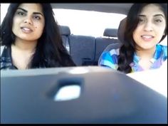 two women sitting in the back seat of a car