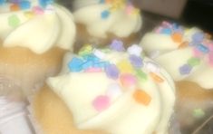 some cupcakes with white frosting and sprinkles