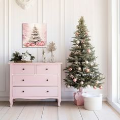 a pink chest of drawers next to a christmas tree