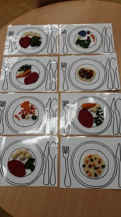 four plates with different types of food on them sitting on top of a wooden table