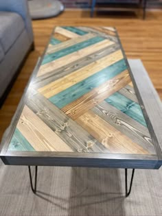 a coffee table made out of wooden planks and metal hairpin legs on a rug