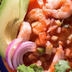 a bowl filled with shrimp, beans and avocado