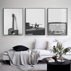 three black and white photographs hang on the wall above a couch in a living room