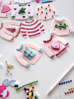 several pieces of clothing and accessories are laid out on a white surface with beading